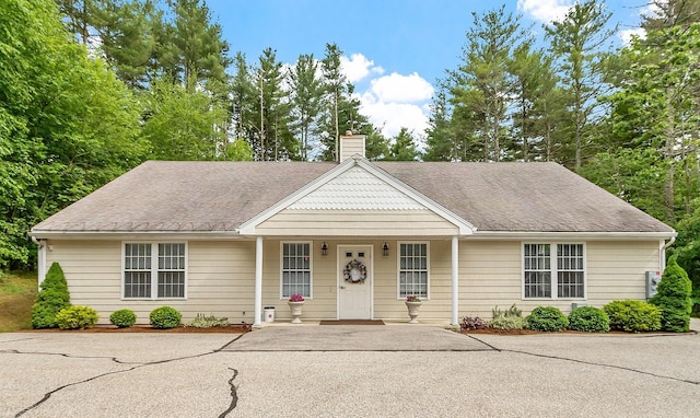 127 Hampton Mdws, Hampton, NH 03842 - view of front of property featuring a chimney, a porch, and a shingled roof