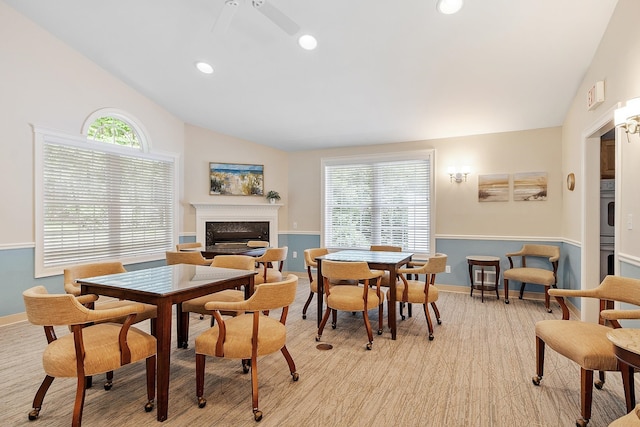 127 Hampton Mdws, Hampton, NH 03842 - dining area featuring a premium fireplace, lofted ceiling, recessed lighting, and ceiling fan