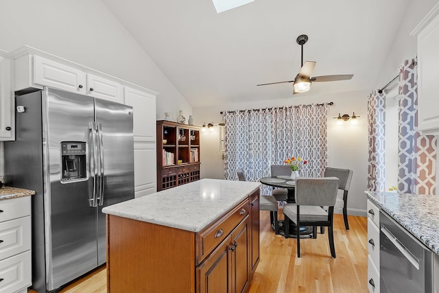 127 Hampton Mdws, Hampton, NH 03842 - kitchen with appliances with stainless steel finishes, lofted ceiling, light wood finished floors, white cabinetry, and a ceiling fan
