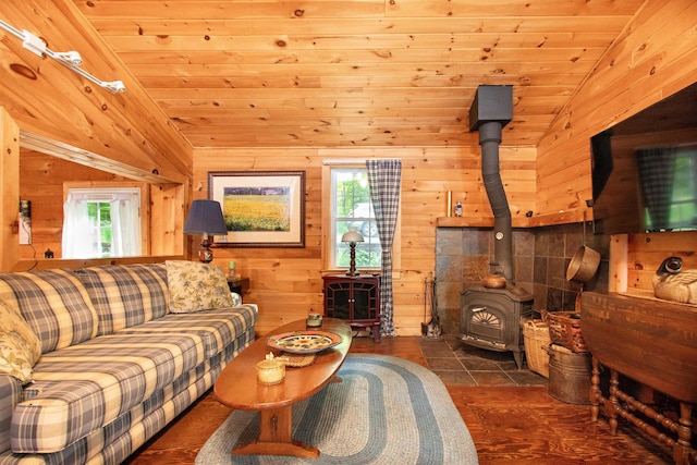 491 The Ln, Peacham, VT 05862 - tiled living room featuring vaulted ceiling, a wood stove, healthy amount of natural light, wooden walls, and wooden ceiling