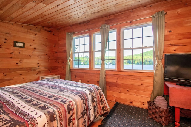 491 The Ln, Peacham, VT 05862 - bedroom with multiple windows, wood walls, and wooden ceiling