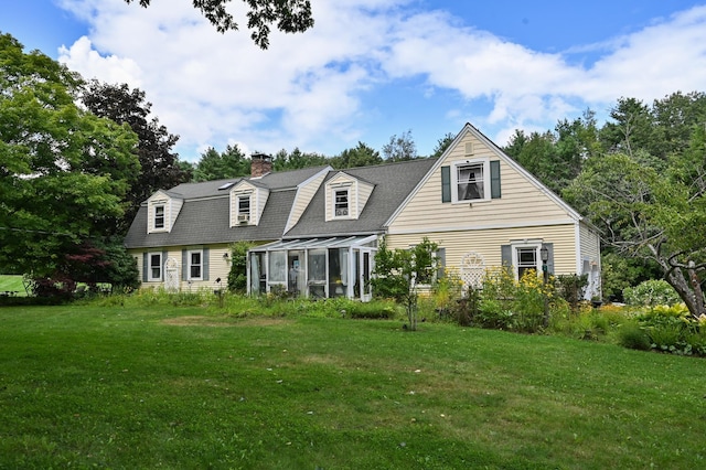 90 Giles Rd, East Kingston, NH 03827 - view of front of property featuring a chimney, a sunroom, and a front lawn
