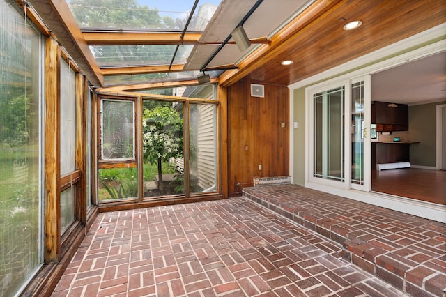 90 Giles Rd, East Kingston, NH 03827 - unfurnished sunroom with a skylight, brick floors, wooden walls, recessed lighting, and a baseboard heating unit