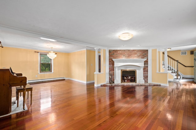 90 Giles Rd, East Kingston, NH 03827 - unfurnished living room with baseboard heating, wood finished floors, a brick fireplace, crown molding, and stairway