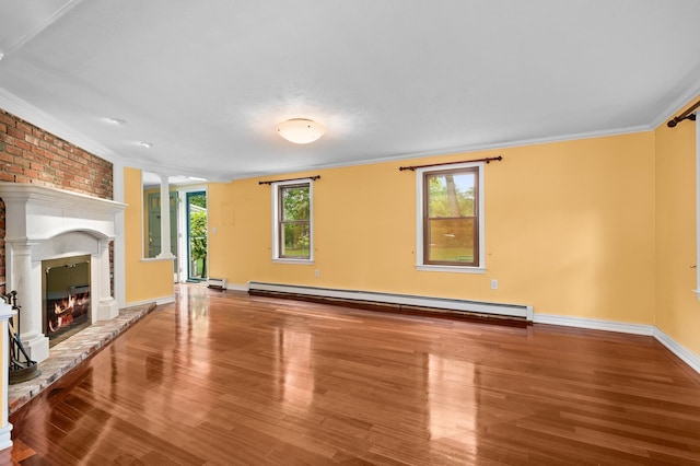 90 Giles Rd, East Kingston, NH 03827 - unfurnished living room featuring baseboard heating, crown molding, wood finished floors, ornate columns, and a brick fireplace