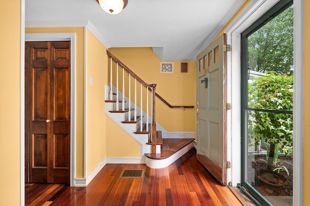 90 Giles Rd, East Kingston, NH 03827 - foyer featuring wood finished floors, stairway, and crown molding