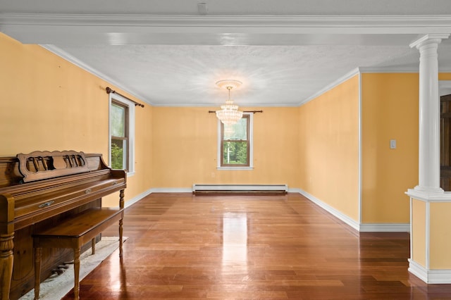 90 Giles Rd, East Kingston, NH 03827 - spare room with baseboard heating, wood finished floors, decorative columns, a chandelier, and crown molding