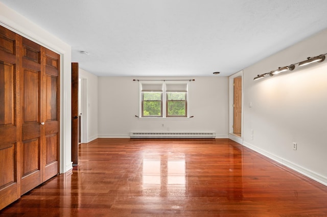 90 Giles Rd, East Kingston, NH 03827 - spare room with a baseboard heating unit and wood finished floors