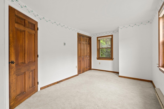 90 Giles Rd, East Kingston, NH 03827 - unfurnished bedroom with light colored carpet, baseboard heating, and a closet