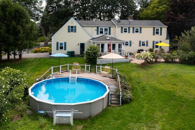 90 Giles Rd, East Kingston, NH 03827 - view of pool with a hot tub, a wooden deck, a lawn, and view of scattered trees