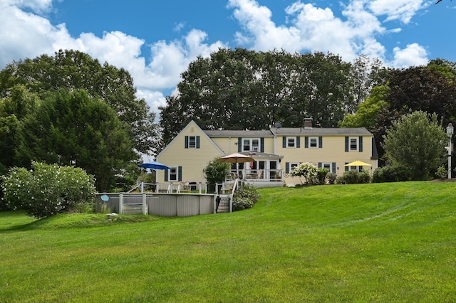 90 Giles Rd, East Kingston, NH 03827 - rear view of house featuring a yard, a chimney, and an outdoor pool