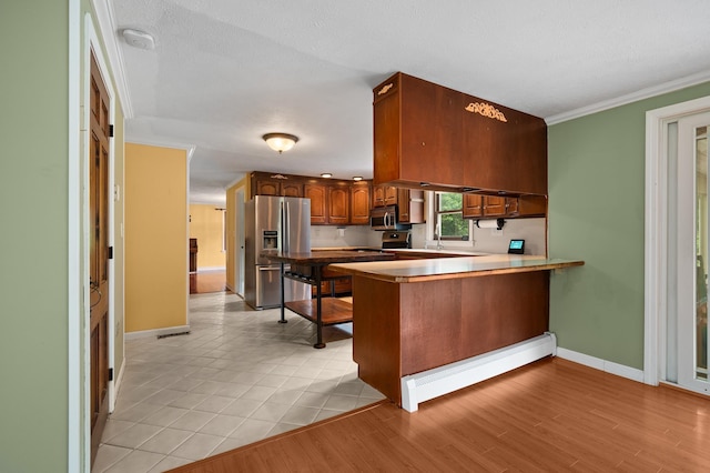 90 Giles Rd, East Kingston, NH 03827 - kitchen featuring appliances with stainless steel finishes, baseboard heating, a peninsula, crown molding, and a breakfast bar area