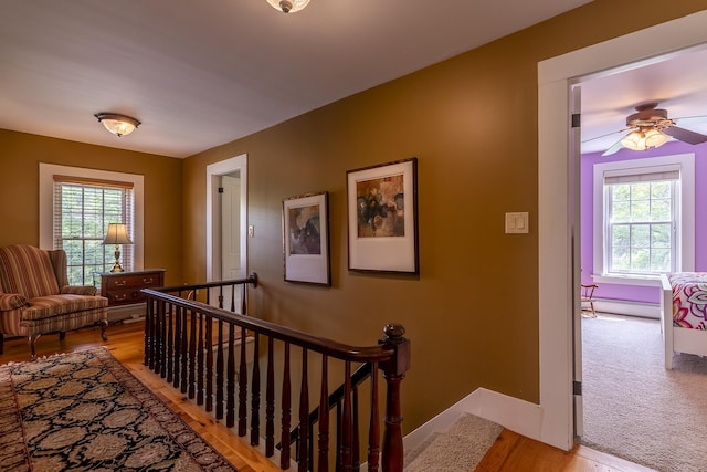 331 Rte 100 N, Plymouth, VT 05056 - hall with an upstairs landing, plenty of natural light, a baseboard radiator, and light wood-style flooring