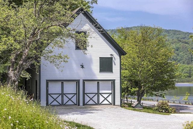 331 Rte 100 N, Plymouth, VT 05056 - garage featuring driveway and a forest view
