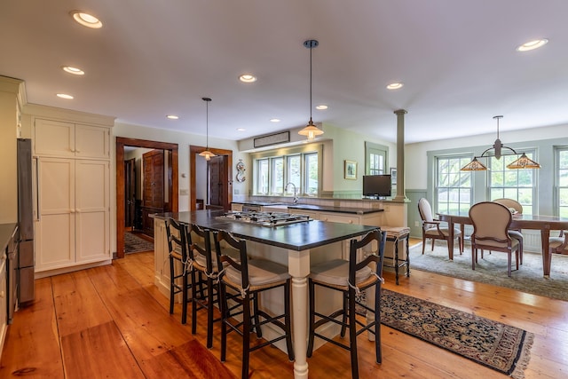 331 Rte 100 N, Plymouth, VT 05056 - kitchen with appliances with stainless steel finishes, dark countertops, light wood-style floors, a kitchen breakfast bar, and recessed lighting