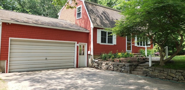 8 Woodridge Rd, Durham, NH 03824 - view of property exterior featuring roof with shingles, asphalt driveway, a gambrel roof, and a garage