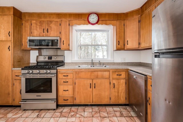 8 Woodridge Rd, Durham, NH 03824 - kitchen with stainless steel appliances, light countertops, and brown cabinets