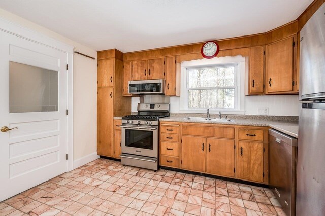 8 Woodridge Rd, Durham, NH 03824 - kitchen with stainless steel appliances, brown cabinetry, and light countertops