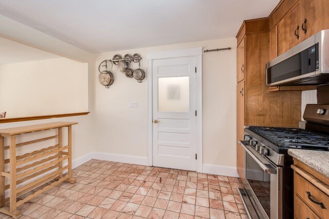 8 Woodridge Rd, Durham, NH 03824 - kitchen featuring stainless steel appliances, brown cabinetry, and light countertops