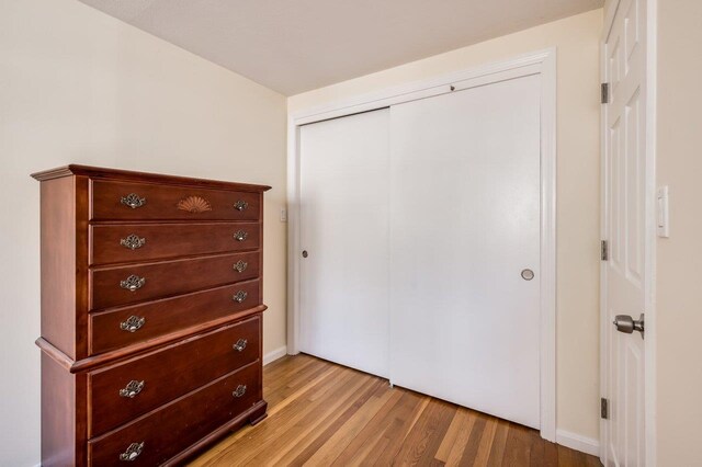 8 Woodridge Rd, Durham, NH 03824 - bedroom with light wood finished floors and a closet
