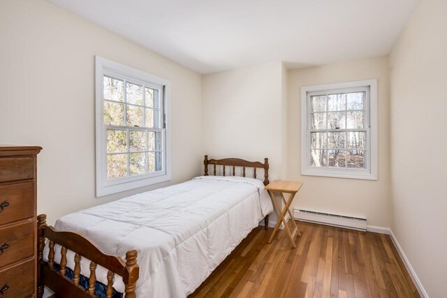 8 Woodridge Rd, Durham, NH 03824 - bedroom featuring baseboard heating and wood finished floors