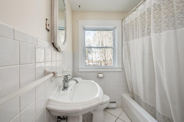 8 Woodridge Rd, Durham, NH 03824 - bathroom featuring baseboard heating, tile walls, tile patterned floors, and shower / bath combo with shower curtain