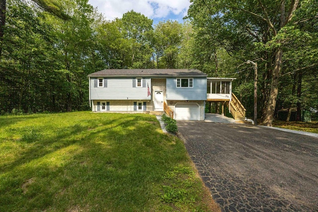 222 Daniel Webster Hwy, Boscawen, NH 03303 - split foyer home with asphalt driveway, stairway, a garage, a front lawn, and a sunroom