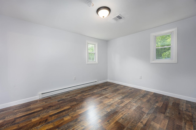 222 Daniel Webster Hwy, Boscawen, NH 03303 - empty room featuring a baseboard heating unit, a smoke detector, and dark wood-type flooring