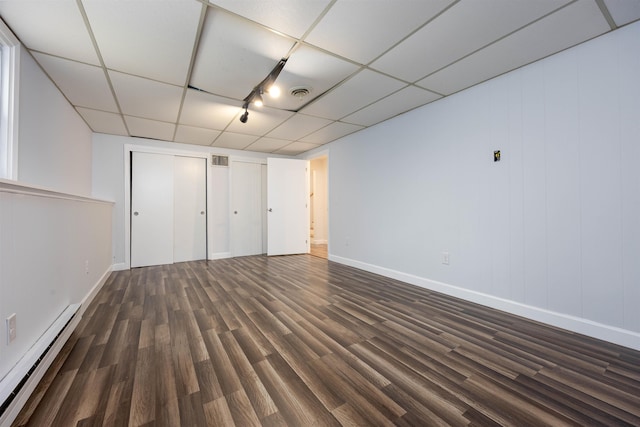 222 Daniel Webster Hwy, Boscawen, NH 03303 - unfurnished bedroom featuring a baseboard radiator, dark wood-type flooring, a drop ceiling, and rail lighting