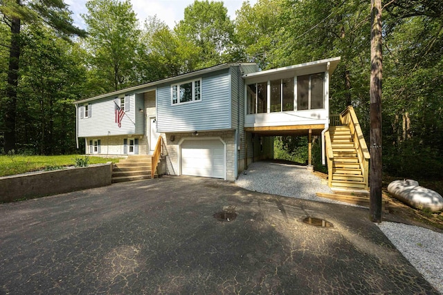 222 Daniel Webster Hwy, Boscawen, NH 03303 - raised ranch featuring stairs, a sunroom, driveway, and an attached garage