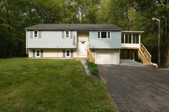 222 Daniel Webster Hwy, Boscawen, NH 03303 - bi-level home featuring a sunroom, an attached garage, driveway, stairs, and a front yard