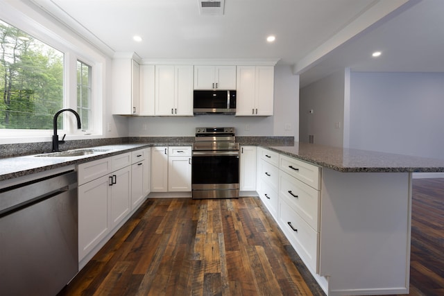 222 Daniel Webster Hwy, Boscawen, NH 03303 - kitchen featuring stainless steel appliances, a peninsula, dark stone counters, white cabinets, and recessed lighting