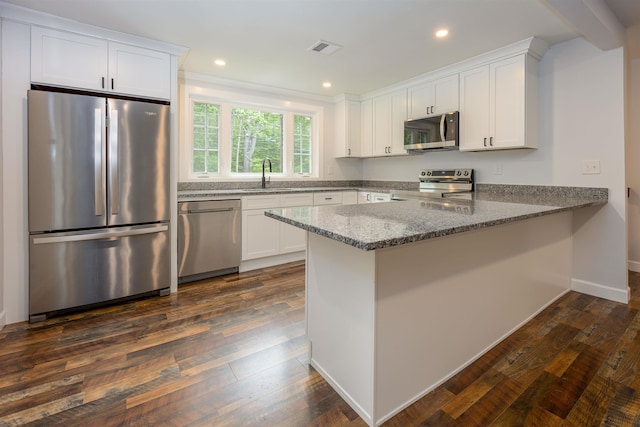 222 Daniel Webster Hwy, Boscawen, NH 03303 - kitchen with appliances with stainless steel finishes, a peninsula, white cabinetry, stone countertops, and dark wood finished floors