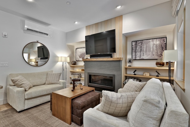 144 Lodge Rd Unit 5, Ludlow, VT 05149 - living area with a wall mounted air conditioner, a glass covered fireplace, and recessed lighting