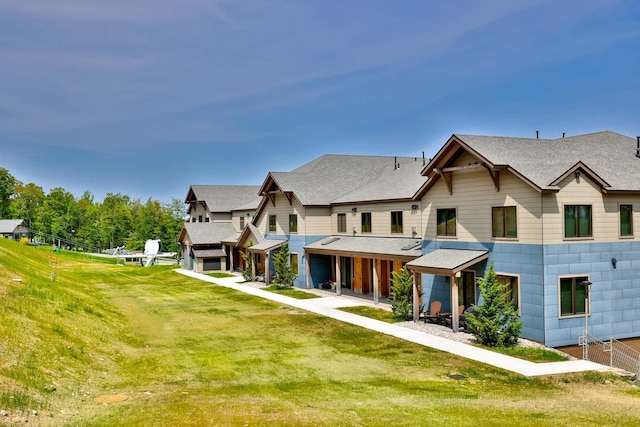 144 Lodge Rd Unit 5, Ludlow, VT 05149 - view of front of house featuring a front yard and a shingled roof