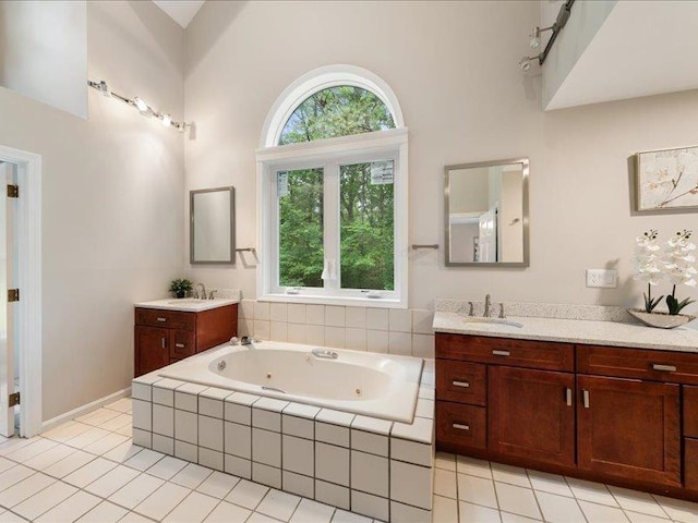 71 Marblehead Rd, Windham, NH 03087 - bathroom with two vanities, a tub with jets, and tile patterned floors