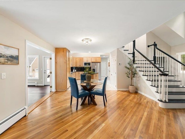 71 Marblehead Rd, Windham, NH 03087 - dining area featuring a baseboard heating unit, stairway, and light wood-type flooring