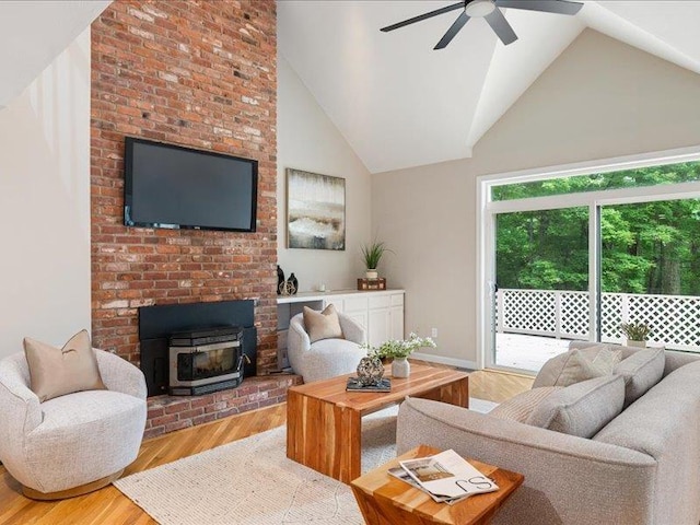 71 Marblehead Rd, Windham, NH 03087 - living room featuring a wood stove, wood finished floors, a ceiling fan, and high vaulted ceiling