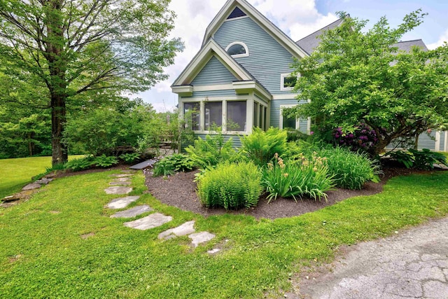 650 Perry Lea Rd, Waterbury, VT 05676 - view of front facade featuring a sunroom and a front lawn