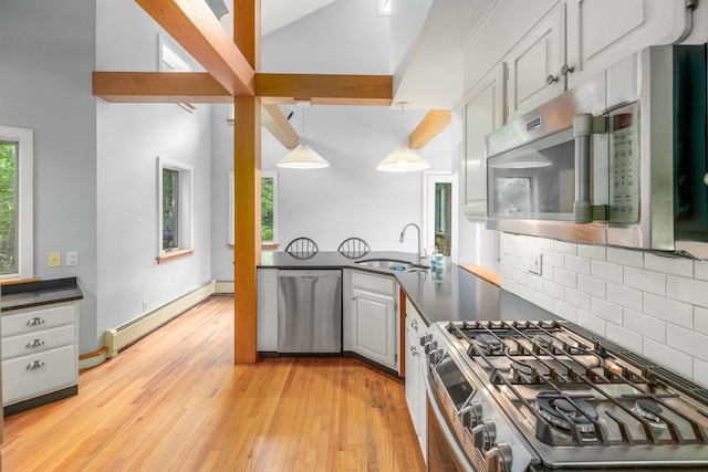 650 Perry Lea Rd, Waterbury, VT 05676 - kitchen featuring stainless steel appliances, a baseboard heating unit, dark countertops, tasteful backsplash, and light wood finished floors