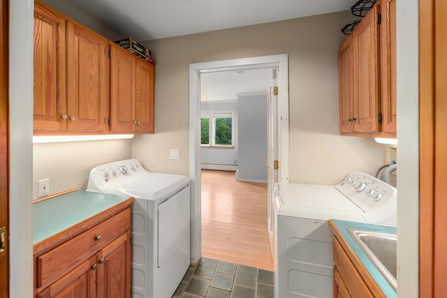 650 Perry Lea Rd, Waterbury, VT 05676 - laundry room with washer and clothes dryer, cabinet space, a baseboard heating unit, and dark tile patterned flooring