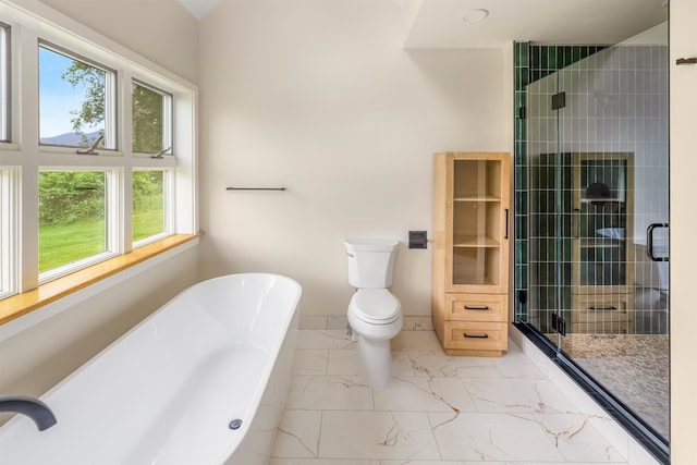 650 Perry Lea Rd, Waterbury, VT 05676 - bathroom featuring marble look tiles, a soaking tub, and a shower stall
