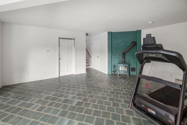 650 Perry Lea Rd, Waterbury, VT 05676 - workout area with a wood stove and baseboards