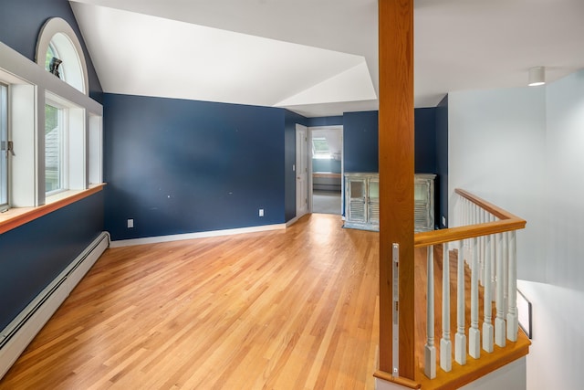 650 Perry Lea Rd, Waterbury, VT 05676 - unfurnished room featuring a baseboard heating unit, vaulted ceiling, plenty of natural light, and wood finished floors