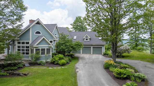 650 Perry Lea Rd, Waterbury, VT 05676 - view of front of property with asphalt driveway, a chimney, a front yard, and a shingled roof