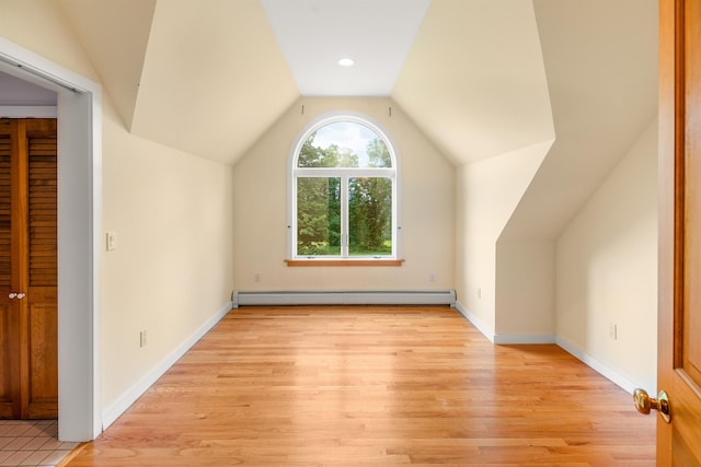 650 Perry Lea Rd, Waterbury, VT 05676 - additional living space with a baseboard heating unit, vaulted ceiling, and light wood-type flooring