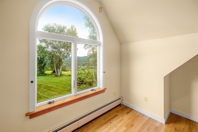650 Perry Lea Rd, Waterbury, VT 05676 - additional living space with baseboard heating, light wood-type flooring, and vaulted ceiling