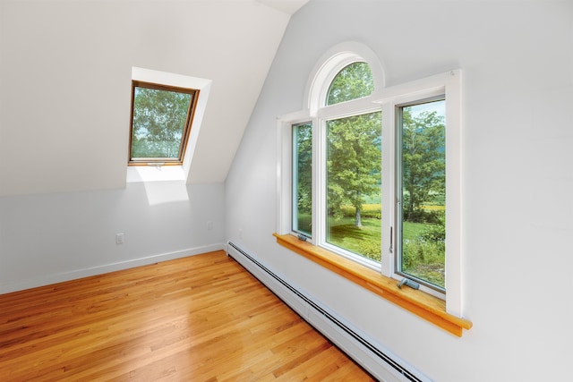 650 Perry Lea Rd, Waterbury, VT 05676 - additional living space with vaulted ceiling, light wood finished floors, and a baseboard radiator