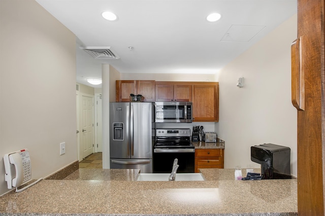 517-519 Jackson Gore Rd Unit 517-519Qtr I, Ludlow, VT 05149 - kitchen with appliances with stainless steel finishes, brown cabinets, recessed lighting, and a peninsula