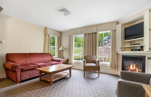 517-519 Jackson Gore Rd Unit 517-519Qtr I, Ludlow, VT 05149 - living room with a glass covered fireplace, light colored carpet, and plenty of natural light